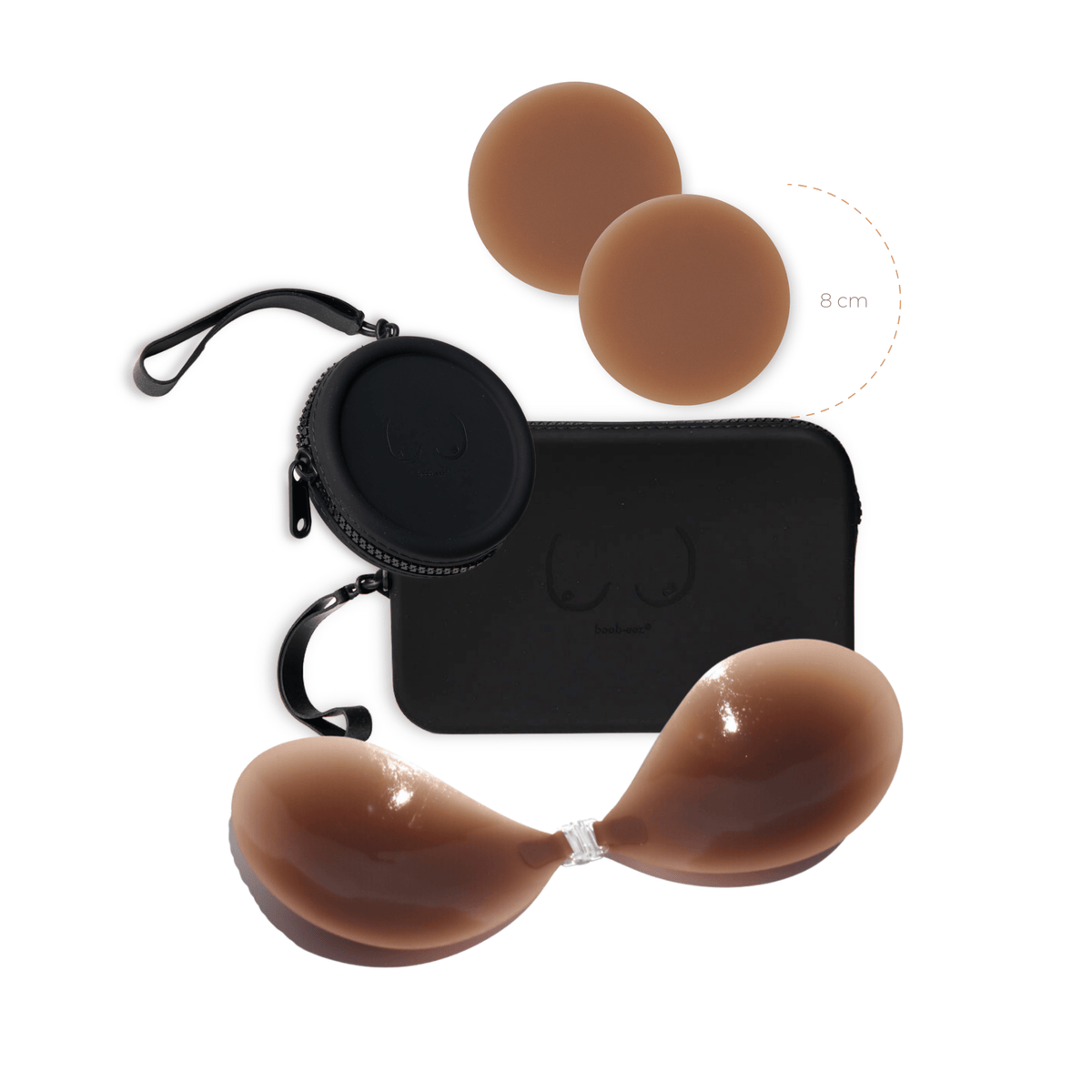 Product shot of a sticky Dark tint 8cm Headlight Hiders and Silicone Stick-on Bra with a durable Silicone Travel Cases in Black and informative insert card with wear and care instructions, close-up front shot showing the Boob-eez branded Silicone Travel Case with a zipper detail and removable strap