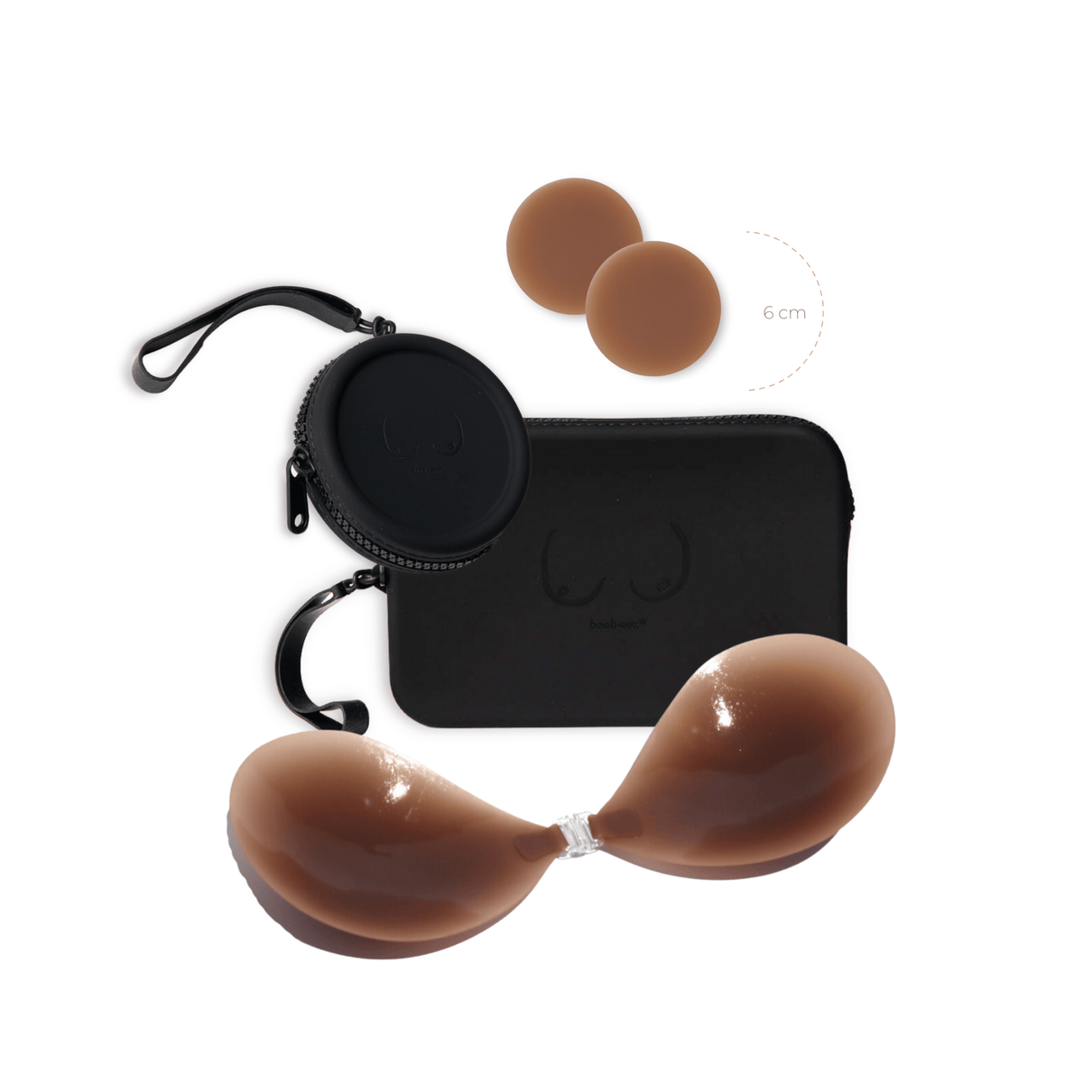 Product shot of a sticky Dark tint 6cm Headlight Hiders and Silicone Stick-on Bra with a durable Silicone Travel Cases in Black and informative insert card with wear and care instructions, close-up front shot showing the Boob-eez branded Silicone Travel Case with a zipper detail and removable strap