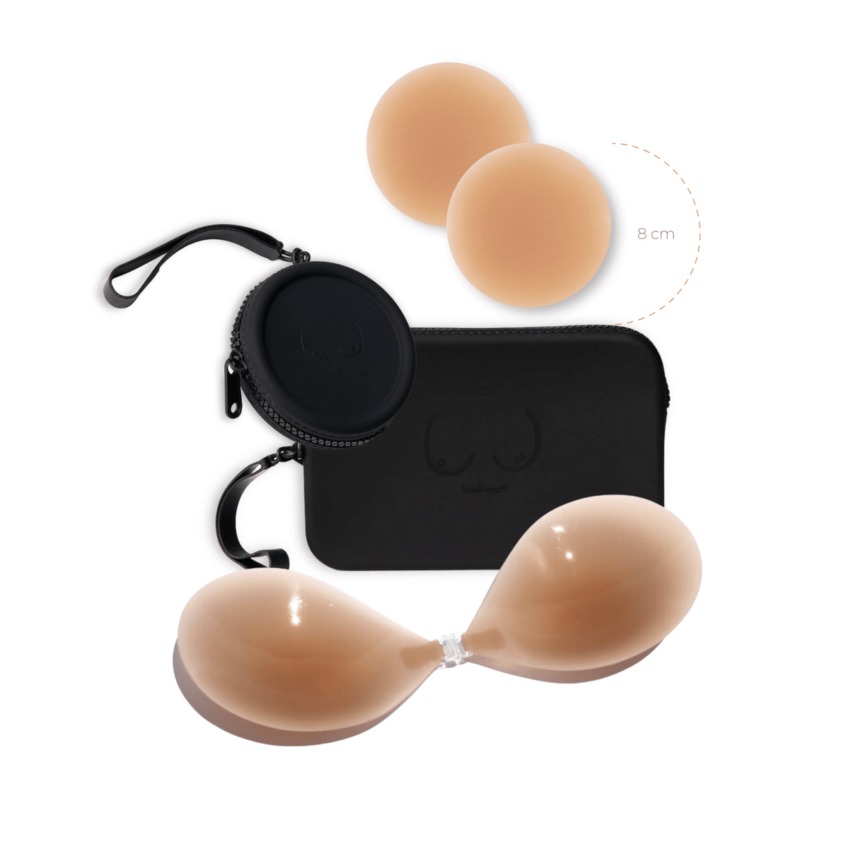 Product shot of a sticky Medium tint 8cm Headlight Hiders and Silicone Stick-on Bra with a durable Silicone Travel Cases in Black and informative insert card with wear and care instructions, close-up front shot showing the Boob-eez branded Silicone Travel Case with a zipper detail and removable strap