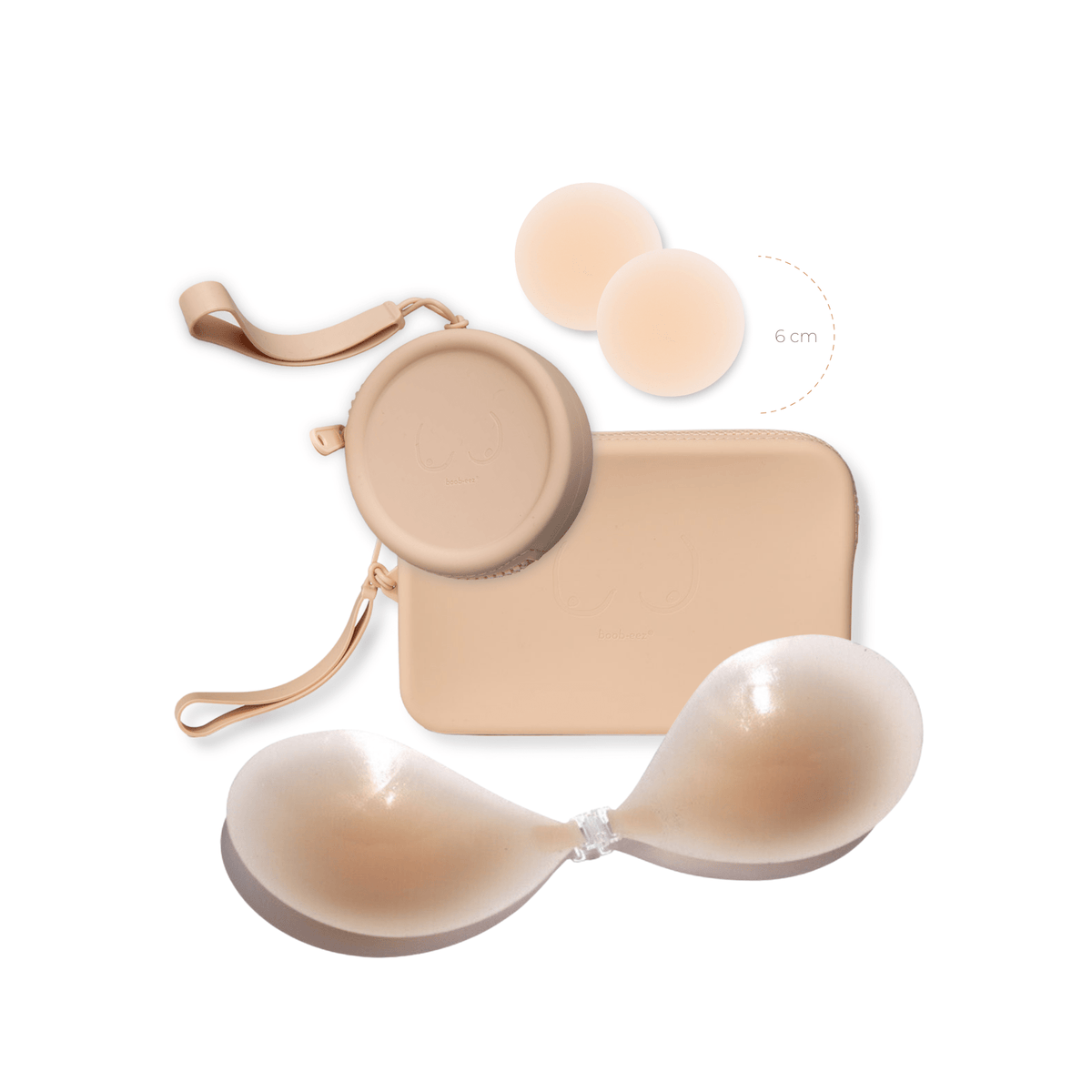 Product shot of reusable Light tint 6cm Headlight Hiders and sticky Silicone Travel Case for Headlight Hiders and a Silicone Travel Case for a sticky Stick-on Bra in Light Nude with a removable strap and zipper detail, against a white background showing the thin edges of the Headlight Hiders