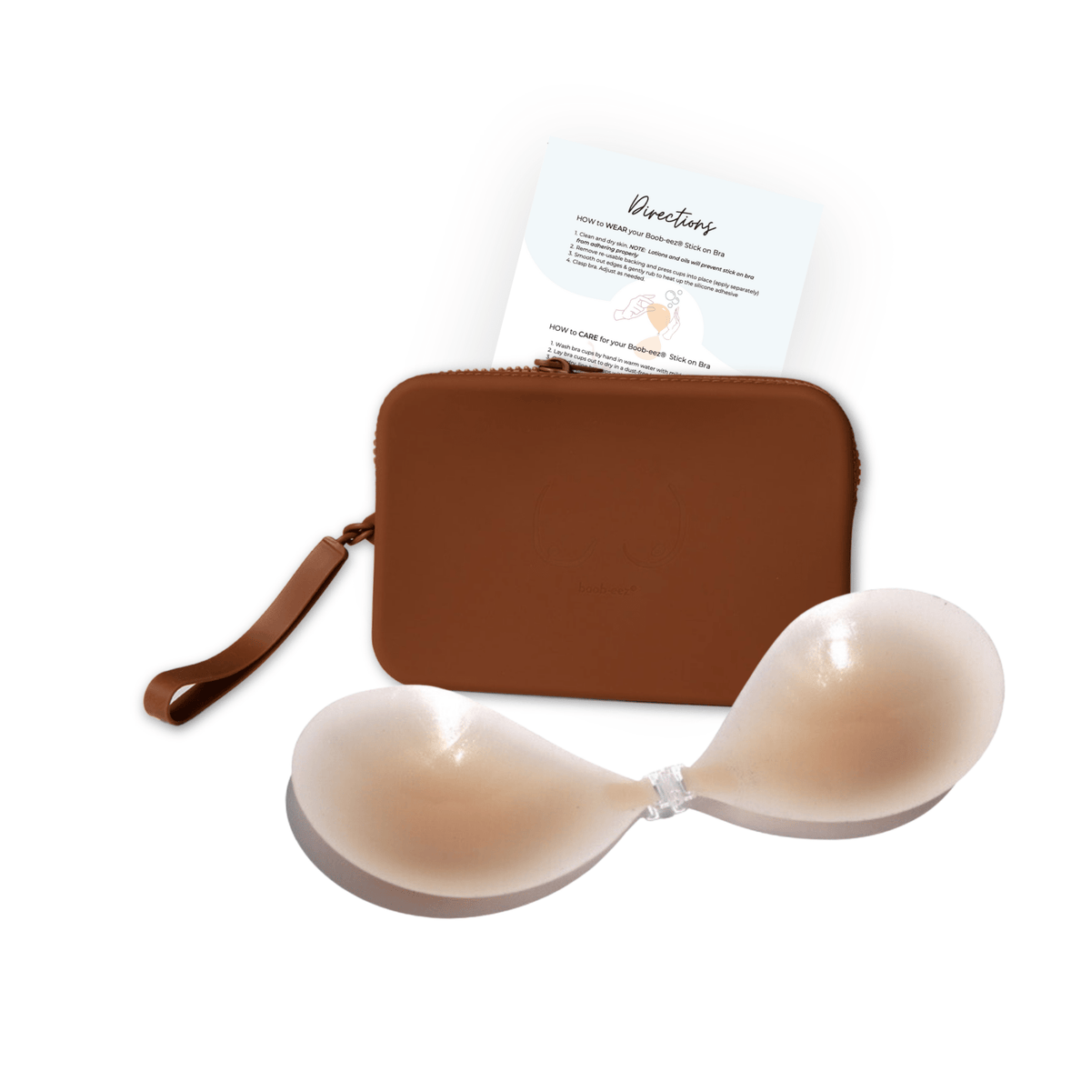 Product shot of sticky Light tint Silicone Stick-on Bra and durable Silicone Travel Case for Silicone Stick-on Bras in Dark Nude and information insert card with wear and care instructions, against a white background showing the thin edges of the Silicone Stick-on Bra