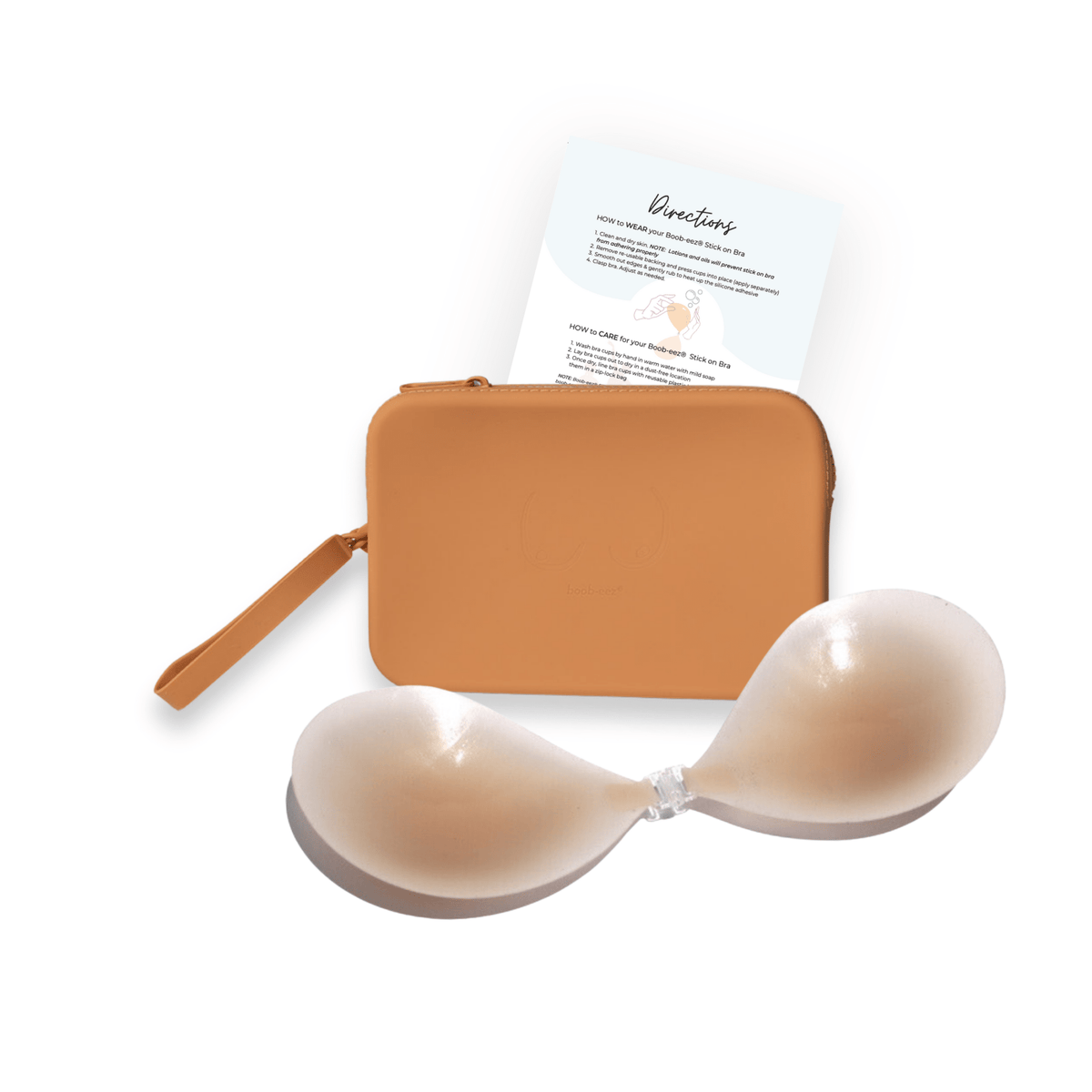 Product shot of sticky Light tint Silicone Stick-on Bra and durable Silicone Travel Case for Silicone Stick-on Bras in Medium Nude and information insert card with wear and care instructions, against a white background showing the thin edges of the Silicone Stick-on Bra