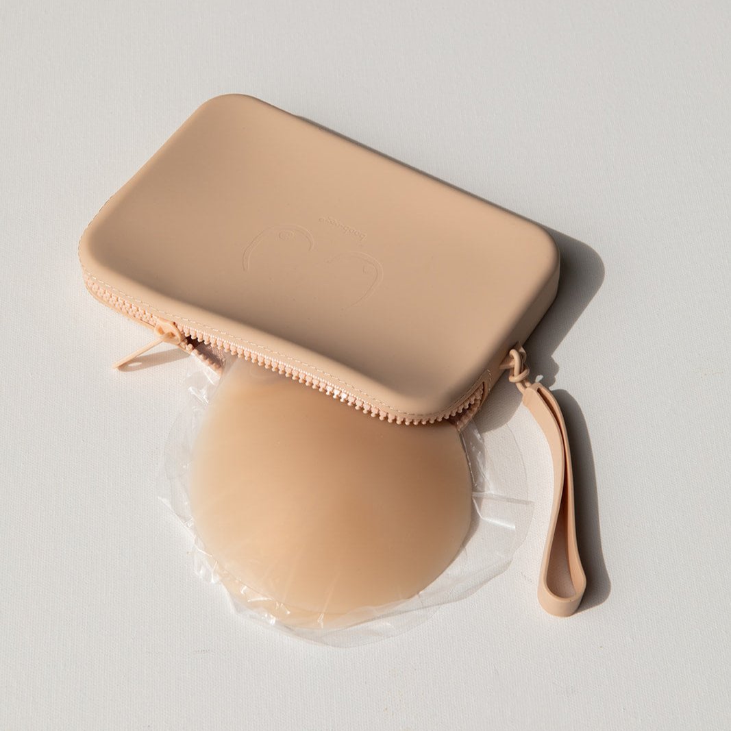 Product shot of our sticky Silicone Stick-on Bra in Light tint and a durable Silicone Travel Case for the Silicone Stick-on Bra in Light Nude, close-up shot showing the Boob-eez branded case and removable strap
