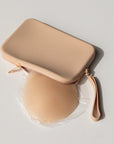 Product shot of our sticky Silicone Stick-on Bra in Light tint and a durable Silicone Travel Case for the Silicone Stick-on Bra in Light Nude, close-up shot showing the Boob-eez branded case and removable strap