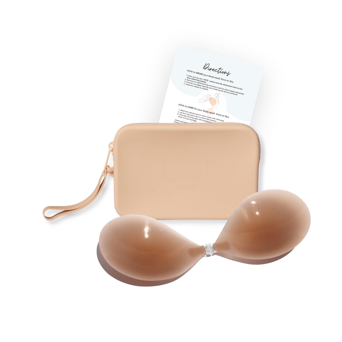 Product shot of sticky Medium tint Silicone Stick-on Bra and durable Silicone Travel Case for Silicone Stick-on Bras in Light Nude and information insert card with wear and care instructions, against a white background showing the thin edges of the Silicone Stick-on Bra