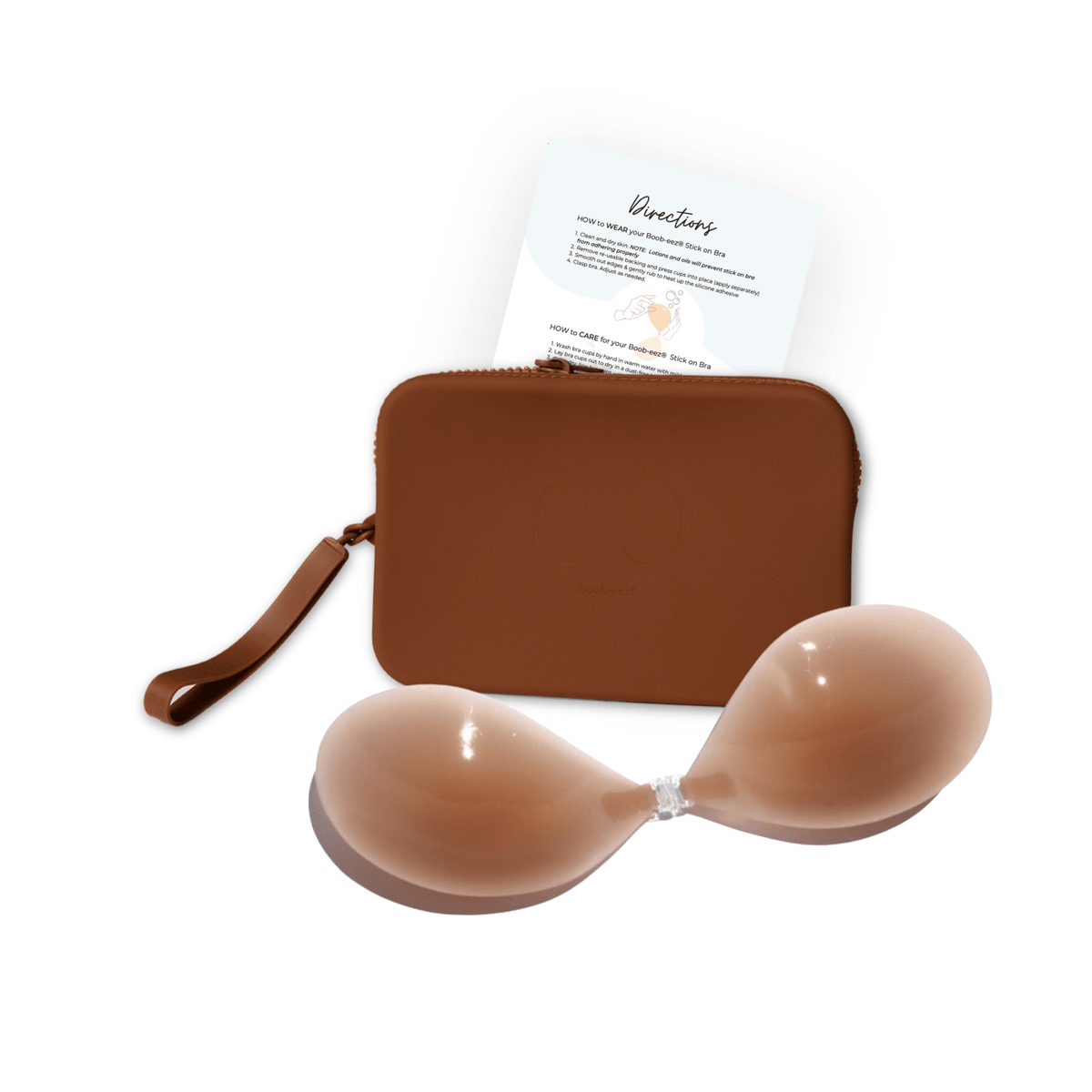 Product shot of sticky Medium tint Silicone Stick-on Bra and durable Silicone Travel Case for Silicone Stick-on Bras in Dark Nude and information insert card with wear and care instructions, against a white background showing the thin edges of the Silicone Stick-on Bra