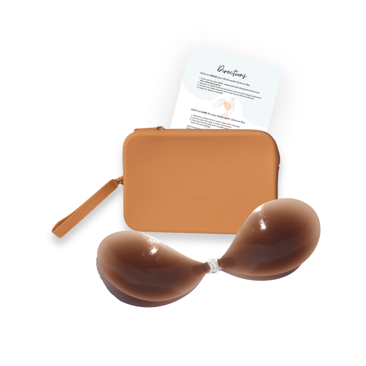 Product shot of sticky Dark tint Silicone Stick-on Bra and durable Silicone Travel Case for Silicone Stick-on Bras in Medium Nude and information insert card with wear and care instructions, against a white background showing the thin edges of the Silicone Stick-on Bra