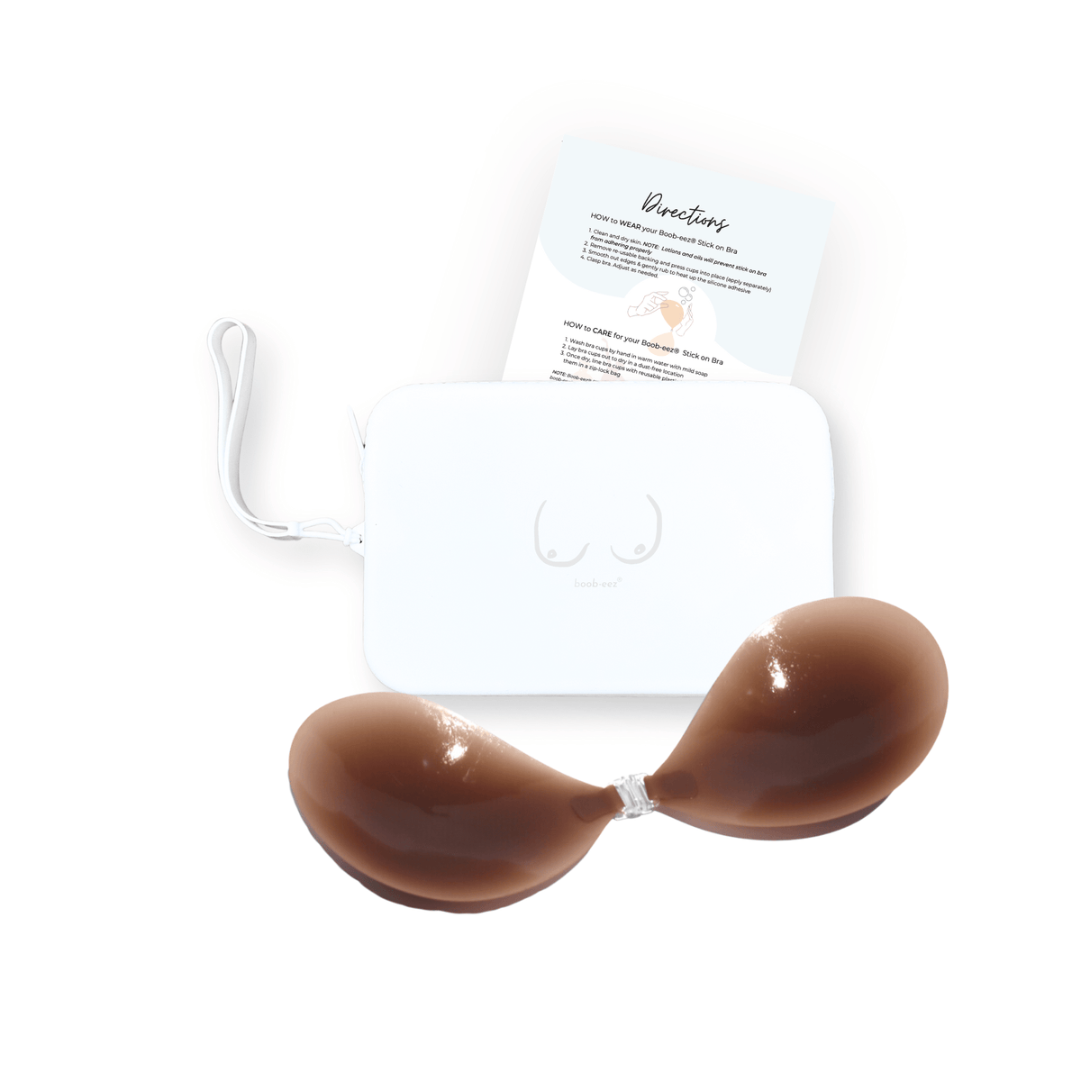 Product shot of sticky Dark tint Silicone Stick-on Bra and durable Silicone Travel Case for Stick-on Bras in White and information card with wear and care instructions, against a white background showing the thin edges of the Silicone Stick-on Bra