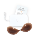 Product shot of sticky Dark tint Silicone Stick-on Bra and durable Silicone Travel Case for Stick-on Bras in White and information card with wear and care instructions, against a white background showing the thin edges of the Silicone Stick-on Bra