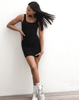 Product shot of NŪD Apparel Tayler Slip Dress, wide strap, fitted style and seamless, made of bamboo fabric produced in California, in Black on medium-skinned model, front shot