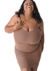 Product shot of NŪD Apparel Tayler Slip Dress, wide strap, fitted style and seamless, made of bamboo fabric produced in California, in Dark Nude on dark-skinned model, front shot