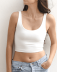 Product shot of NŪD Apparel Devon Double Layered Scoop Crop top, wide strap and seamless, made of bamboo fabric produced in California, in White on fair-skinned model paired with light-wash jeans, front shot