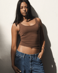 Product shot NŪD Apparel Devon Long Double Layer Scoop, wide strap, perfect length and seamless, made of bamboo fabric produced in California, in Dark Nude on medium-skinned model paired with dark-wash jeans, front shot