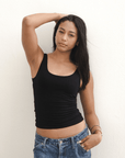 Product shot NŪD Apparel Devon Long Double Layer Scoop, wide strap, perfect length and seamless, made of bamboo fabric produced in California, in Black on medium-skinned model paired with dark-wash jeans, front shot