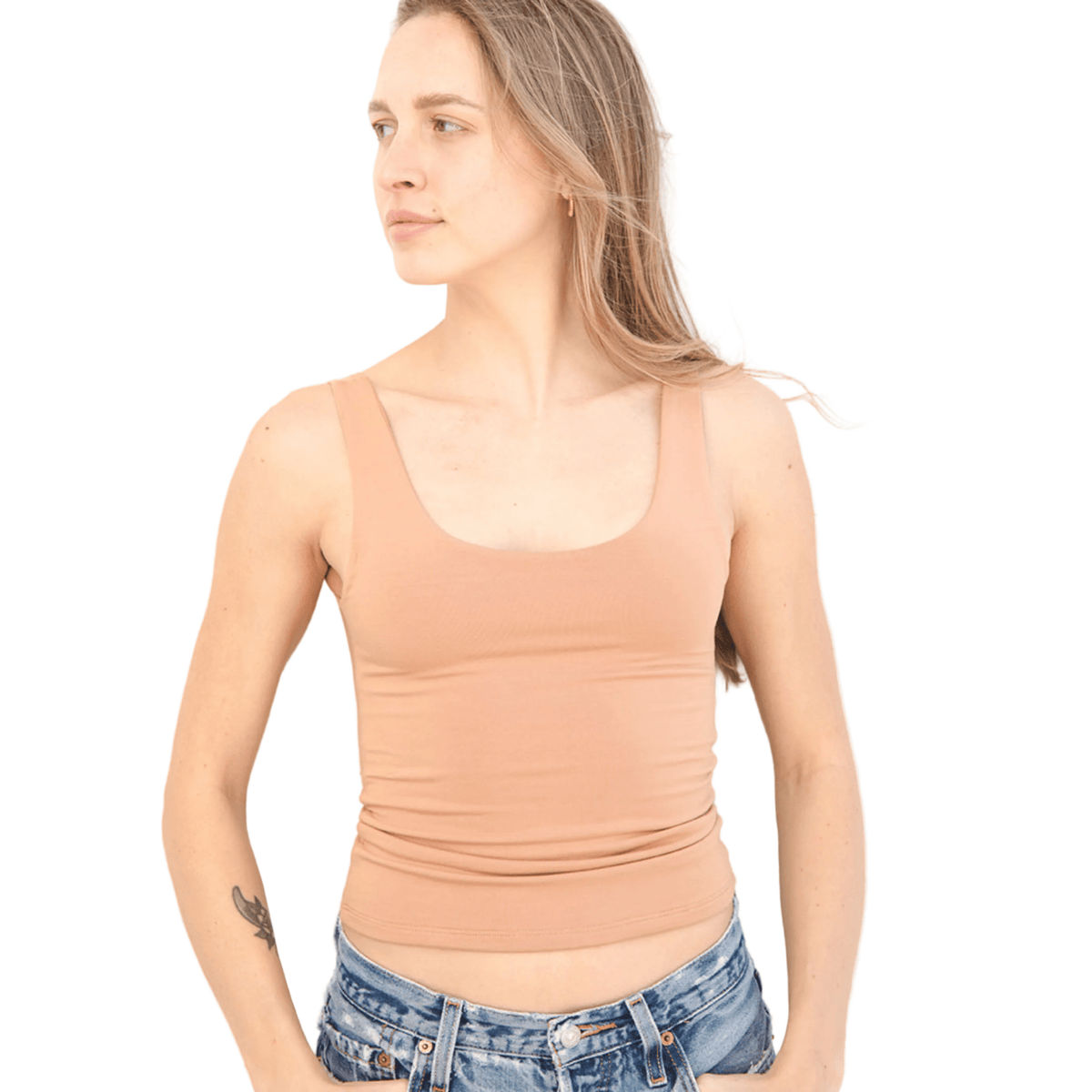 Product shot NŪD Apparel Devon Long Double Layer Scoop, wide strap, perfect length and seamless, made of bamboo fabric produced in California, in Medium Nude on fair-skinned model paired with light-wash jeans, front shot