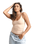 Product shot of NŪD Apparel Nesha Double Layered Tank, thin strap, long style and seamless, made of bamboo fabric produced in California, in Light Nude on medium-skinned model paired with light-wash jeans, front shot
