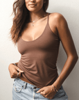 Product shot of NŪD Apparel Nesha Double Layered Tank, thin strap, long style and seamless, made of bamboo fabric produced in California, in Dark Nude on medium-skinned model paired with light-wash jeans, front shot