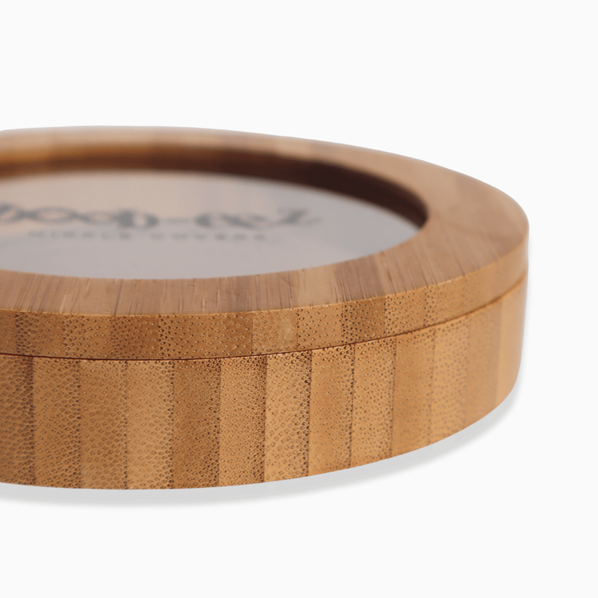 Product shot of the Boob-eez Bamboo Compact, close-up side shot showing the beautiful wood grain detail from the bamboo used to make the compact