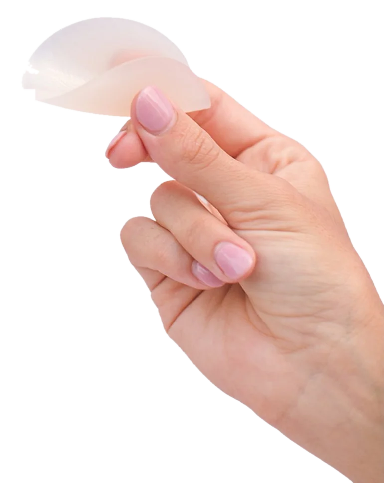 Hand holding an ultra-thin Boob-eez silicone cover